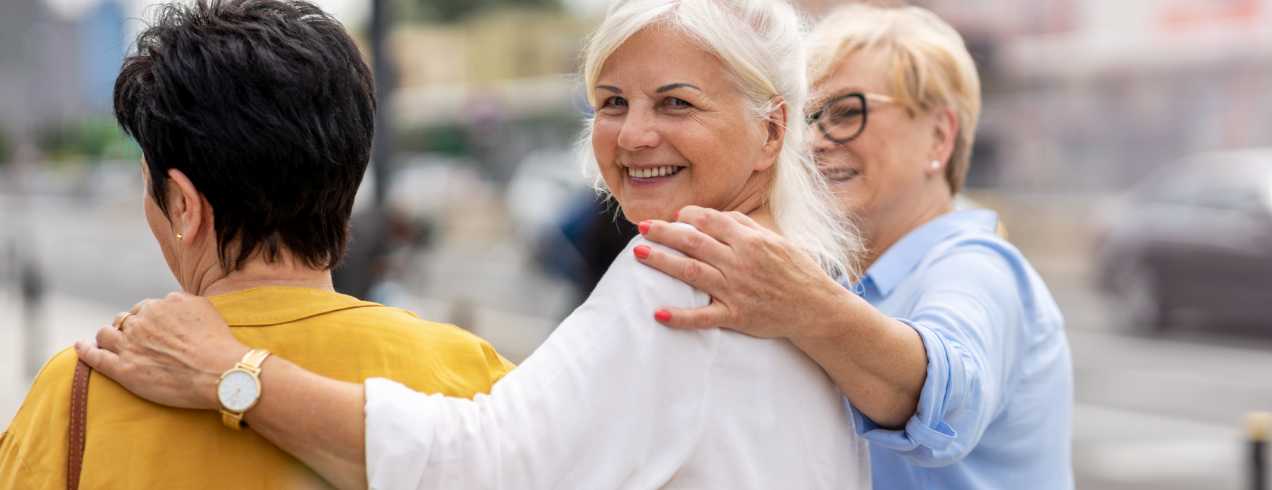 Smiling elderly women in a group discussion about what Medicare is.