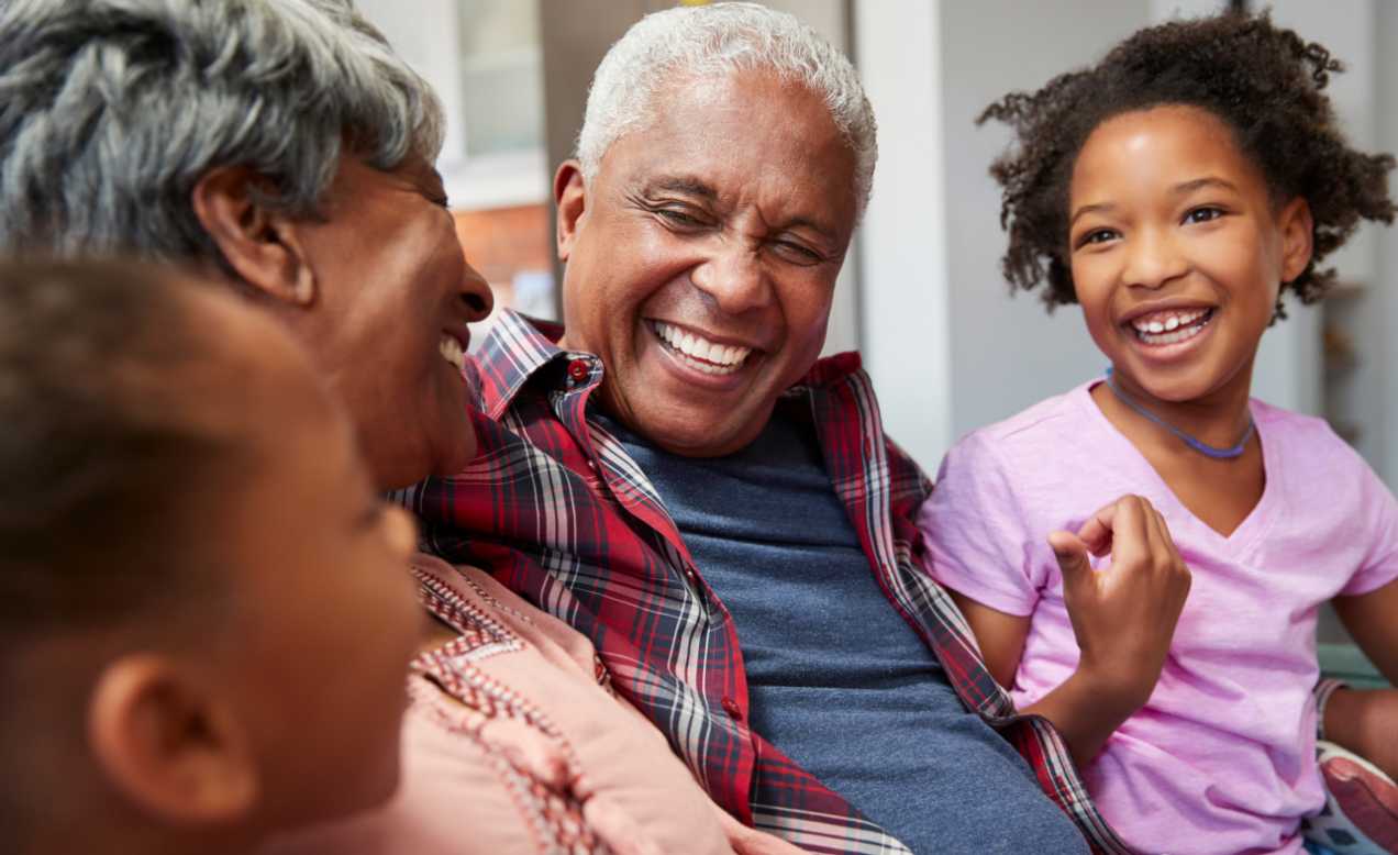 Happy grandparents laughing with their grandchildren.