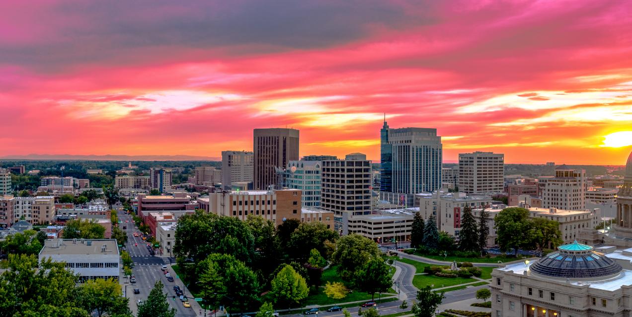A pink and yellow sunset over a city in Idaho