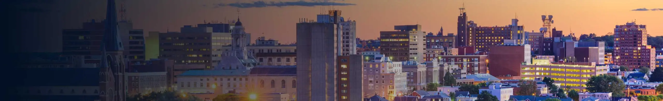 The skyline of a Maine city at sunset