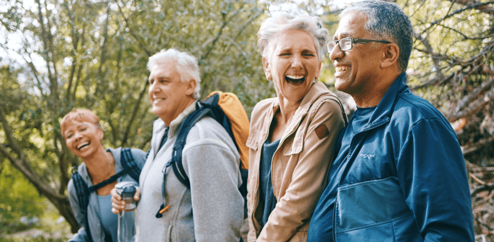 Group of hikers smiling in a green forest